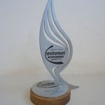 The image features a silver award with a wooden base. It displays text that reads "Yorkshires Finest Environmental Award 2012. Awarded to Revive Leeds".
