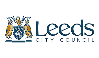Features a crest with three owls surrounding a blue banner. To the right text is displayed that reads "Leeds City Council" in navy blue.